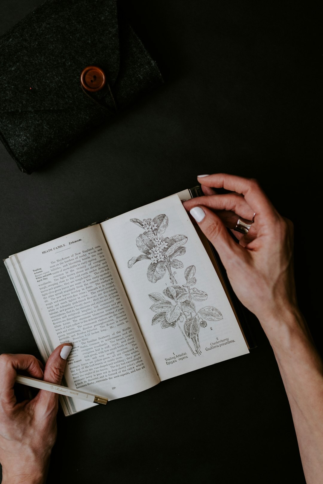 Woman writing thoughts in a journal at a wooden desk